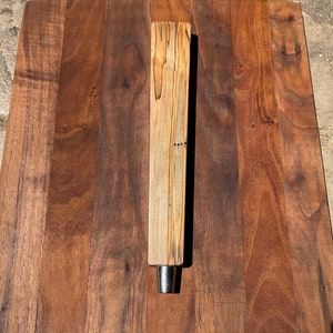 May include: A wooden beer tap handle with a natural wood finish and a metal tap.