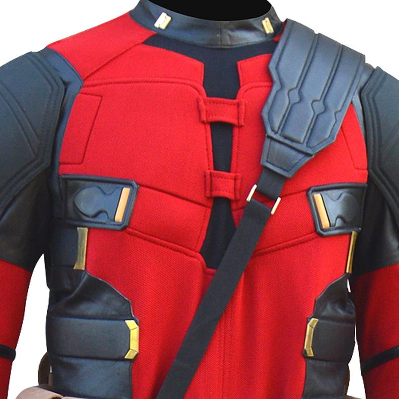 May include: Red and black costume with a black shoulder strap. The costume has a red torso with black accents on the shoulders, arms, and chest. Gold-colored details are visible on the chest and shoulders. The costume has a black collar.