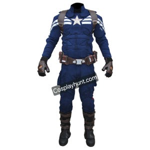 May include: A Captain America costume, featuring a navy blue jumpsuit with a white star emblem on the chest. The costume includes a brown belt, gloves, boots, and a harness. The text "Cosplayhunt.com" is visible.