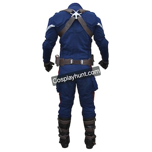 May include: A blue Captain America costume, viewed from the back. The outfit includes a jacket, pants, belt, and boots. The jacket has a white star on the back and brown straps. The pants have red stripes on the sides. The boots are brown with buckles. The text "Cosplayhunt.com" is visible.