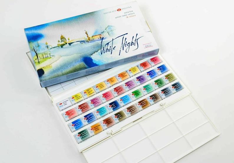 May include: A watercolor paint set with the words "White Nights" on the box. The box features a watercolor painting of a cityscape. Inside, the set contains 36 watercolor paint tubes in various colors, arranged in a white plastic palette.