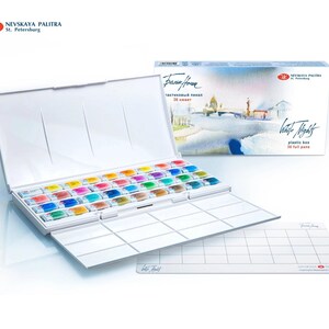 May include: A white plastic watercolor paint box with 36 full pans, open to reveal a rainbow of colors. The box is labeled "White Nights" and includes a separate mixing palette. The brand name "Nevskaya Palitra" is visible.