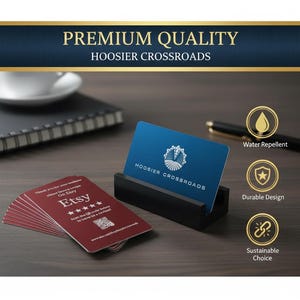 May include: A stack of maroon business cards and a blue business card in a black holder. The blue card displays the text "HOOSIER CROSSROADS" and a logo. The maroon cards have the Etsy logo and a QR code. The image also includes text that says "PREMIUM QUALITY HOOSIER CROSSROADS".
