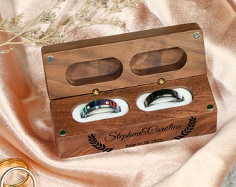 May include: A wooden ring box with two compartments for rings. The box is engraved with the names "Stephen & Caroline" and the date "August 06, 2025".