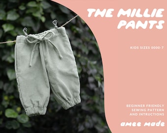 May include: Sage green corduroy pants with a drawstring waist, hanging on a clothesline. The text "THE MILLIE PANTS" is displayed in a playful font, along with "KIDS SIZES 0000-7" and "amee made". The background is a lush green.