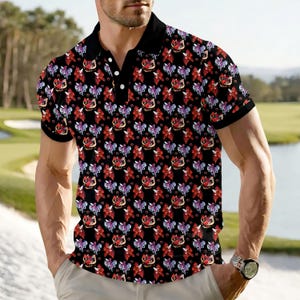 May include: Black polo shirt with a repeating pattern of red, purple, and white floral designs. The shirt has a black collar and short sleeves. The background shows a golf course.
