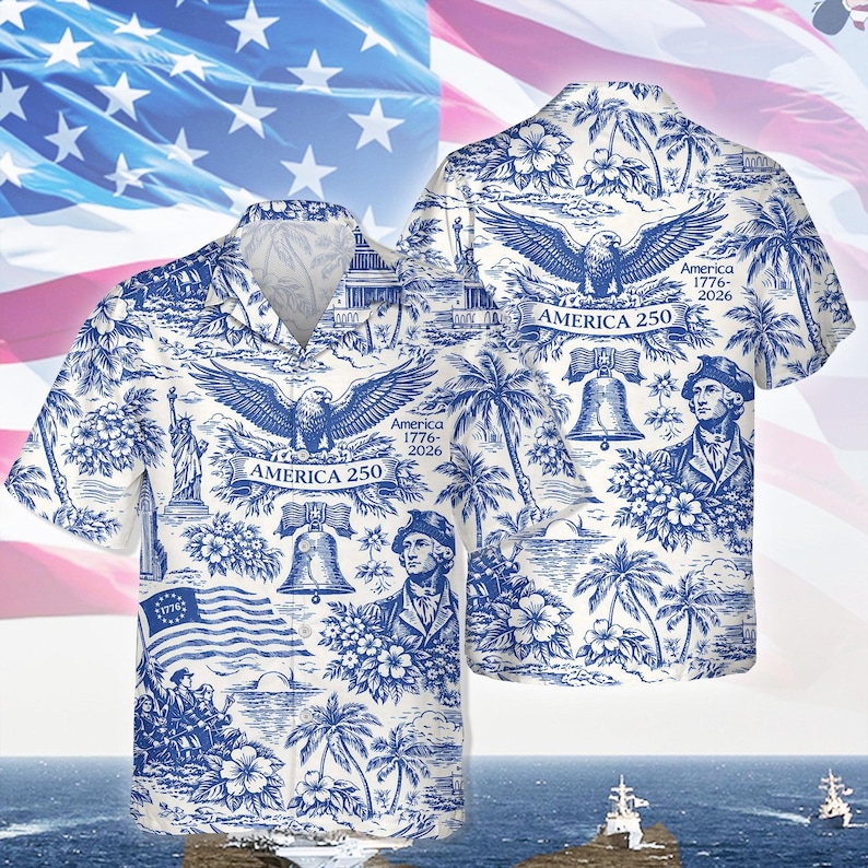 May include: White and blue button-down shirt with a patriotic design. The shirt features illustrations of an eagle, the Statue of Liberty, the Liberty Bell, and historical figures. The text "America 250" and "1776-2026" are also visible.