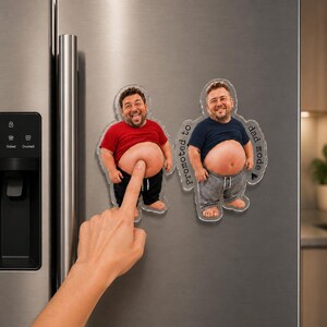 May include: Two custom acrylic magnets featuring a caricature of a man with a bare belly. One magnet shows a man in a red shirt and black pants, the other in a blue shirt and gray pants with the text Promoted to dad mode printed on the side.