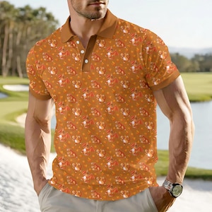 May include: A short-sleeved polo shirt featuring a repeating pattern of cartoon dragons in orange and red on a brown base. The shirt has a brown collar and sleeves, and a three-button placket.