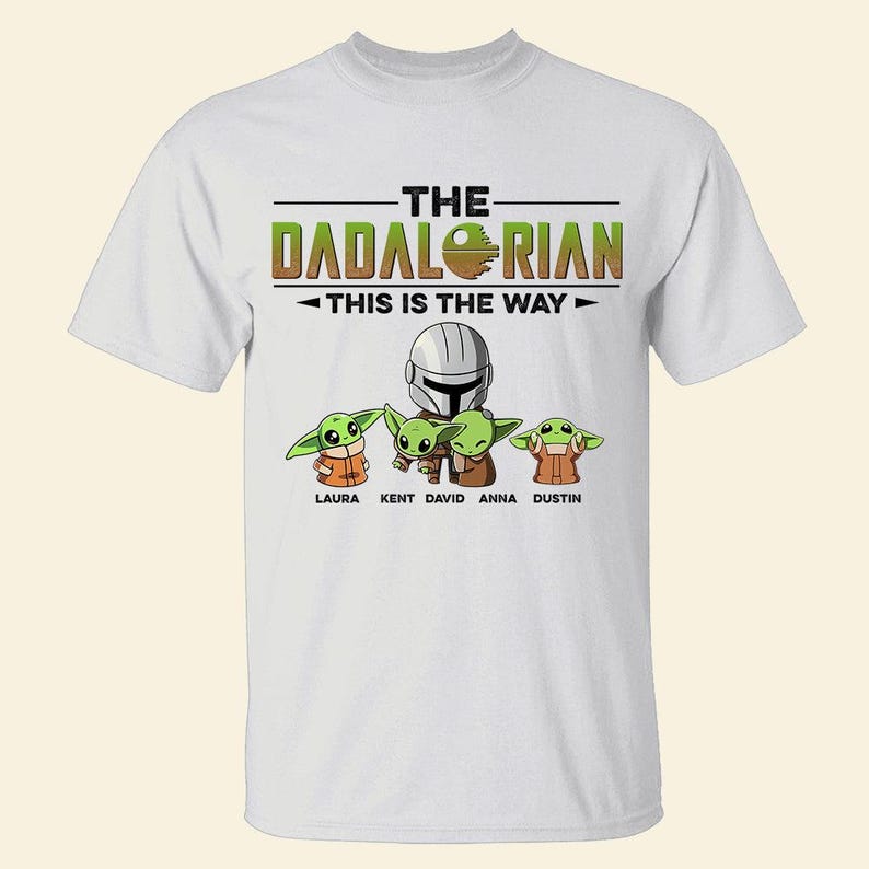 May include: White t-shirt featuring the text "THE DADALORIAN THIS IS THE WAY" above an illustration of a Mandalorian helmet and four Grogu characters. The names Laura, Kent, David, Anna, and Dustin are below the Grogu characters.