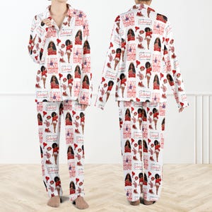 May include: White pyjama set featuring a repeating pattern of red and black illustrations, text, and symbols. The text includes "I AM BLACK HISTORY" and "Sisterhood for me". The illustrations include a woman, trainers, and lips.