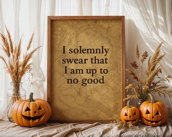 May include: A framed print with the text "I solemnly swear that I am up to no good" sits beside carved orange pumpkins and decorative dried wheat. The print has a map-like background. A Halloween-themed decorative display.