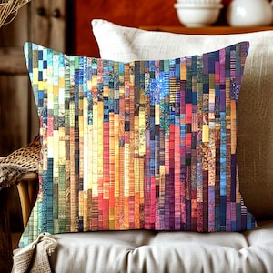 May include: A decorative square pillow with a colorful abstract design. The pillow features vertical stripes in shades of blue, yellow, orange, red, and purple. The design gives the pillow a textured appearance, suitable for home decor.
