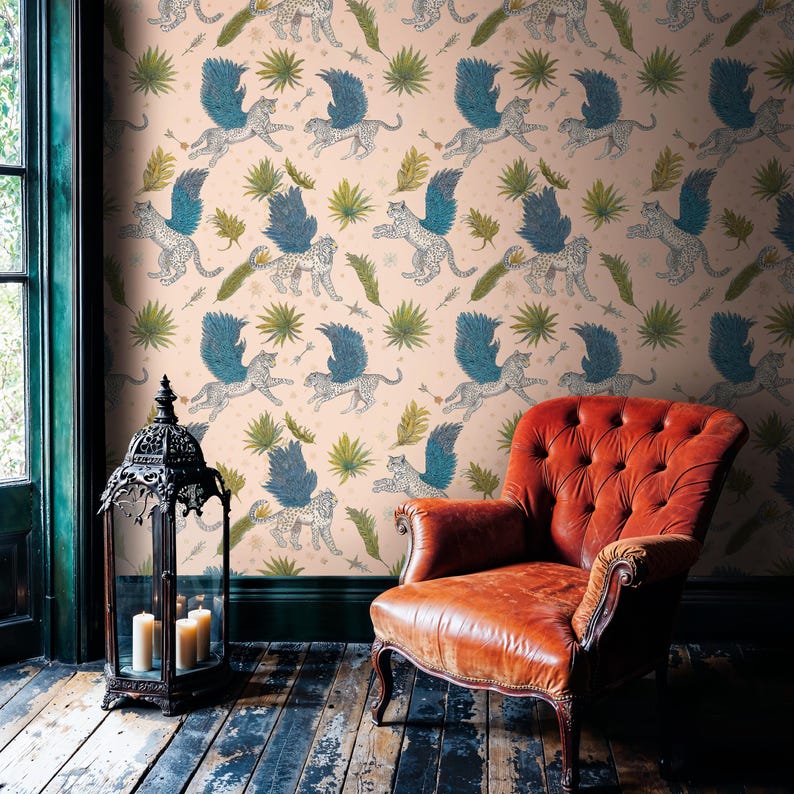 Vintage reading nook with caramel leather wingback chair and Moroccan lantern, walls dressed in Whimsical Winged Wildcat Wall Mural; Secret Garden Mural vibes from enchanted mythical leopard wallpaper on blush-pink ground.