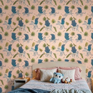 Kid’s bedroom featuring Fantasy Wallpaper, Enchanted Mythical Leopard design with teal wings; blush-pink wall-to-wall print behind ivory headboard and plush panda; Removable Wallpaper option available as traditional mural too.