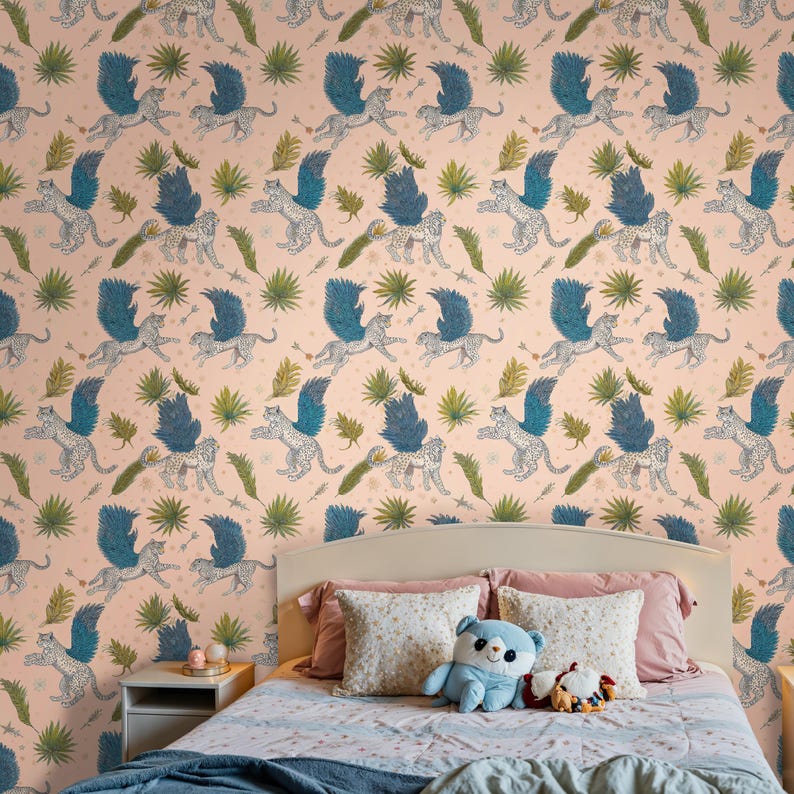 Kid’s bedroom featuring Fantasy Wallpaper, Enchanted Mythical Leopard design with teal wings; blush-pink wall-to-wall print behind ivory headboard and plush panda; Removable Wallpaper option available as traditional mural too.