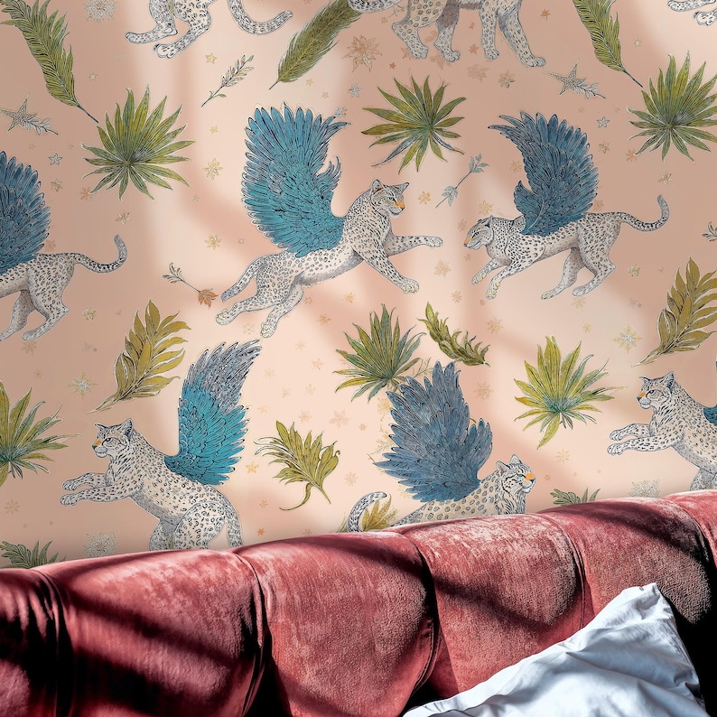 Close-up of Enchanted Mythical Leopard Wallpaper in blush pink; Whimsical Winged Wildcat Wall Mural glows behind a vintage red velvet sofa and soft shadows; Removable Wallpaper for a bold, magic statement wall.
