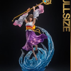 May include: A detailed figurine of a woman in a flowing purple dress with pink floral accents, holding a golden staff with blue accents. She is standing on a blue water-like base, with white and pink sleeves. The word "FULLSIZE" is printed vertically.