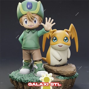 May include: A detailed figurine of a young boy in a green outfit and hat, waving. Beside him is a yellow and white creature with large ears. The base is a rock formation with green grass. The text "GALAXI STL" is at the bottom.