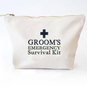 May include: A white canvas zippered pouch with the text "Groom's Emergency Survival Kit" and a black plus sign.