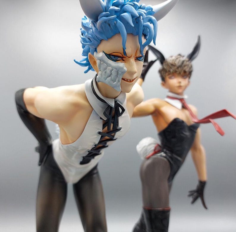 May include: Two figures in bunny costumes. One figure is wearing a white bunny costume with black accents and has blue hair. The other figure is wearing a black bunny costume with a red bow tie.