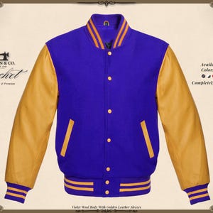 May include: A violet wool body jacket with golden leather sleeves. The jacket has a button-up front, a ribbed collar, cuffs, and hem with gold stripes. The sleeves are a light tan color. The text on the jacket says "KHAN & CO. Jacket Handmade & Premium".