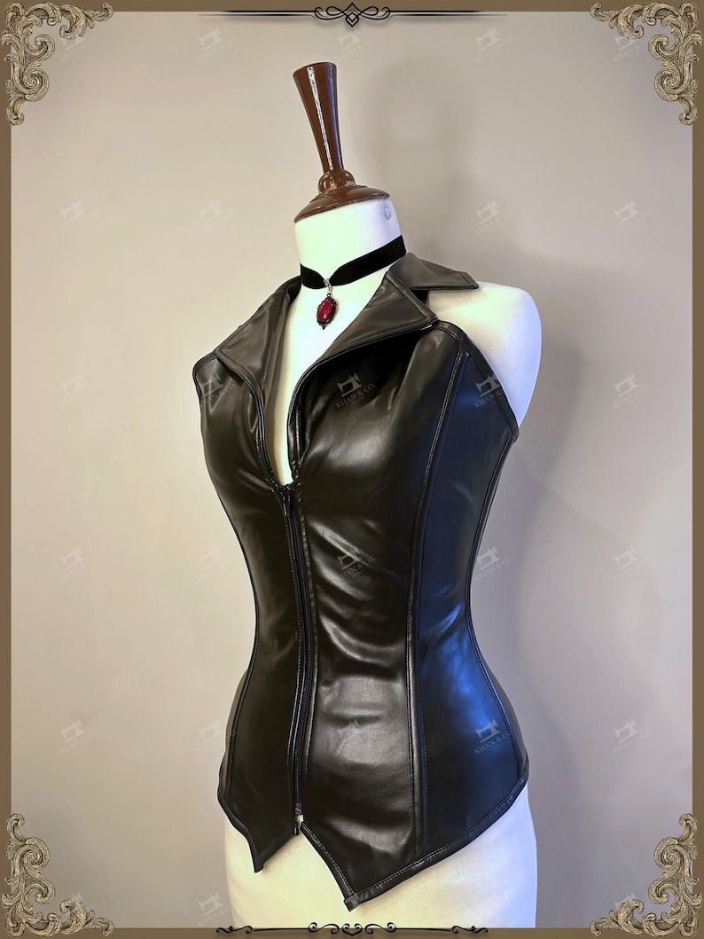 May include: A black faux leather corset top with a zipper closure, displayed on a mannequin. The top features a collar and is paired with a black velvet choker with a red pendant. The corset is designed to accentuate the waist.