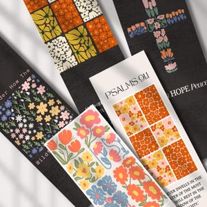 Può includere: Una collezione di segnalibri a tema floreale. I disegni includono una croce, vari motivi floreali e il testo "PSALMS 91:1" e "HOPE Peace". I segnalibri presentano un mix di colori, tra cui arancione, giallo, rosa e blu, su sfondo nero.