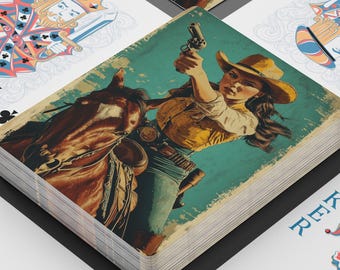 May include: A deck of playing cards with a vintage Western theme. The card backs and the face cards feature illustrations of a cowgirl on a horse, holding a gun. Other cards show traditional suits and a joker card.