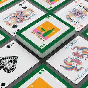 May include: A deck of playing cards with green borders and white faces. The deck features a card with a bottle and glass illustration, the text "DRINK MODERATELY", and other cards with traditional suits and face cards. The Joker card is also visible.