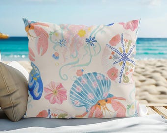 Cojín de exterior con estampado de cangrejo ermitaño y conchas marinas / Manta playera náutica costera
