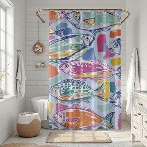 May include: A colorful shower curtain featuring a repeating pattern of stylized fish in shades of orange, pink, green, and blue. The fish are outlined in dark blue against a light blue background, with abstract brushstroke accents.