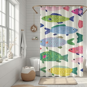 May include: A cream-colored shower curtain featuring colorful, cartoon-style fish in shades of pink, green, blue, and yellow. The fish have various patterns and designs. The curtain is hanging in a bathroom with a window and a woven basket.