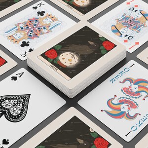 May include: A deck of tarot cards with various illustrations. The "Death" card features a raven, a crystal ball, and red roses. Other cards include a King of Clubs, an Ace of Spades, and a Joker card with a colorful jester design.