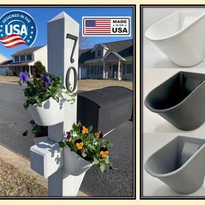 May include: A white wooden post with the number 70 on it. There are three white planter boxes attached to the post, each with flowers growing in them. The planter boxes are designed to be attached to a mailbox post. The planter boxes are made in the USA.