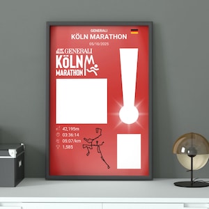 May include: Framed poster with a red background. It features the text "GENERALI KÖLN MARATHON" and the date 05/10/2025. The poster includes a white exclamation mark, a running figure graphic, and marathon statistics.