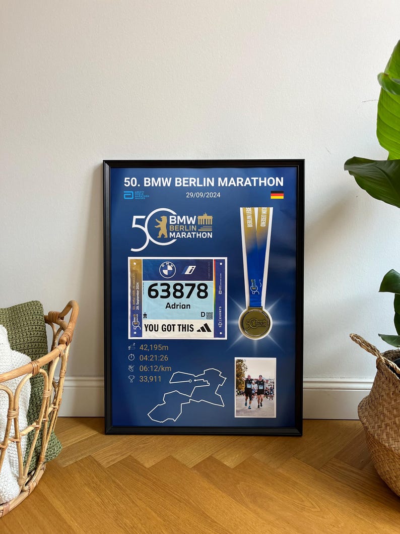 May include: Framed commemorative print for the 50th BMW Berlin Marathon. The print includes a race bib with the number 63878, a medal, and race details. The text "YOU GOT THIS" is also visible.