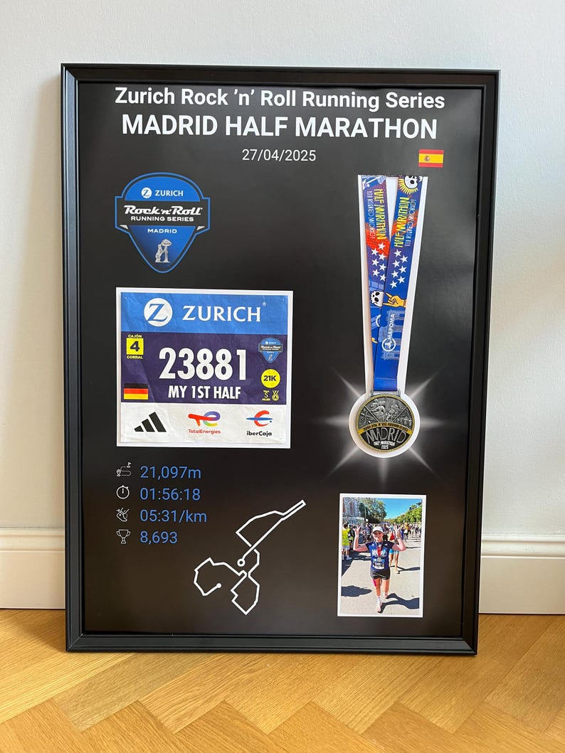 May include: Framed black display featuring a Madrid Half Marathon medal, race bib, and event details. The text "Zurich Rock 'n' Roll Running Series MADRID HALF MARATHON" is displayed at the top, with the date 04/27/2025.