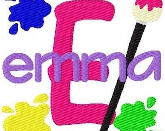May include: A pink letter E with the word "emma" in purple letters, a paintbrush with a black handle and a white paint splatter, and three paint splatters in blue, yellow, and green.