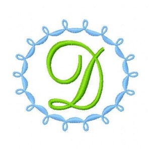 May include: A green letter D in a blue circle with a decorative border. The letter is in a cursive font.
