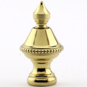 May include: A gold metal finial with a beaded trim and a pointed top. The finial is a decorative element used on furniture, curtains, and other home decor items.