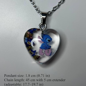 Puede incluir: Collar con colgante en forma de coraz&oacute;n con un dise&ntilde;o de resina transparente. El colgante presenta un personaje de dibujos animados azul y flores secas. La cadena es plateada. Tama&ntilde;o del colgante: 1,8 cm. Longitud de la cadena: 45 cm.