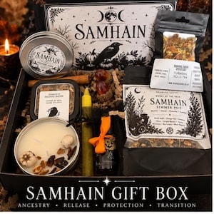 May include: A Samhain gift box containing a candle in a tin with skull and pumpkin wax embeds, a tin of incense, a yellow taper candle, a small bottle with an orange ribbon, a bag of turmeric gold tea, and a bag of Samhain simmer pot ingredients.