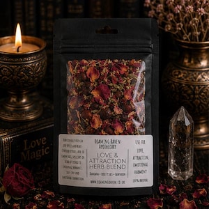 May include: A black resealable pouch containing a dried herb blend of red rose petals and dark berries. The white label reads Roaming Raven Apothecary Love & Attraction Herb Blend, listing ingredients like damiana, rose petals, and hawthorn.