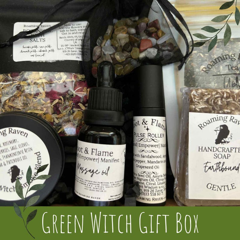 May include: A Green Witch Gift Box featuring a variety of products. Includes a massage oil, pulse roller, soap, bath salts, and a blend of herbs. The products are packaged in a black box with a green banner at the bottom.