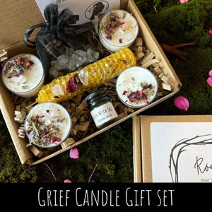May include: A Grief Candle Gift Set in a cardboard box. The set includes four small candles with dried flowers, a yellow honeycomb, a small jar, and a bag of crystals. The text "Grief Candle Gift Set" is at the bottom.