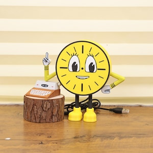 May include: A whimsical yellow clock character with black legs and yellow shoes. It has a smiling face and arms, one pointing up. A small, vintage-style cash register sits on a wooden base next to the clock.