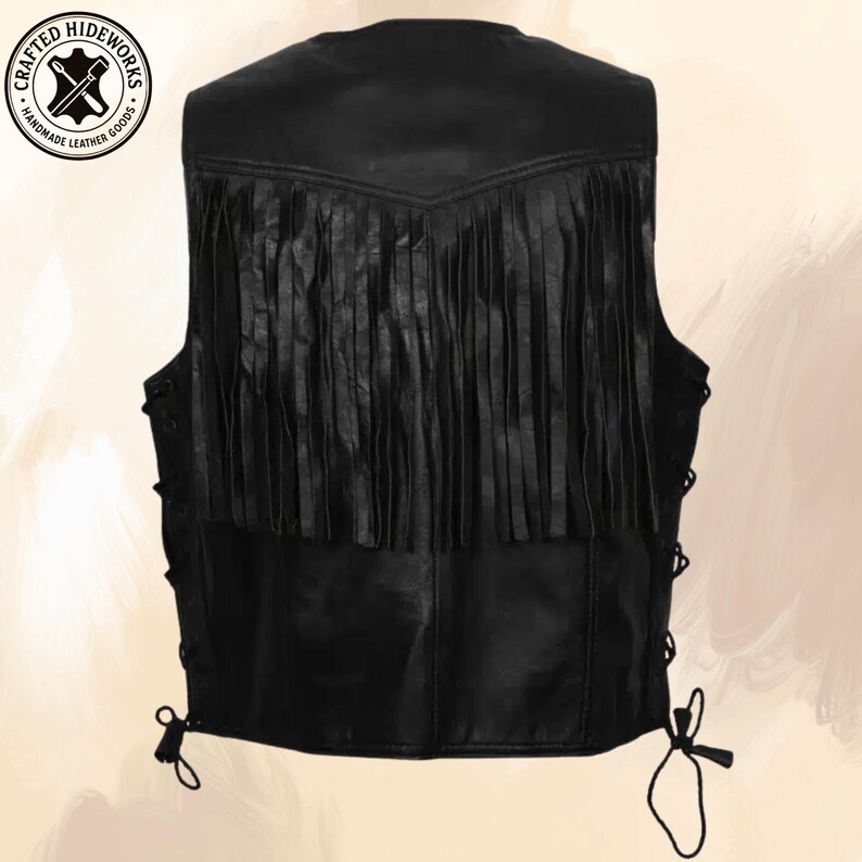 Pu&ograve; includere: Gilet in pelle nera con frange sulla parte superiore della schiena. Il gilet ha lacci laterali per la regolazione e un logo rotondo nell'angolo in alto a sinistra con la scritta "Crafted Hideworks Handmade Leather Goods."