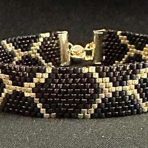 Gouden armband met slangenprint en kralen – Elegant sieraad met pythonpatroon – Donkere, luxe statement armband voor vrouwen