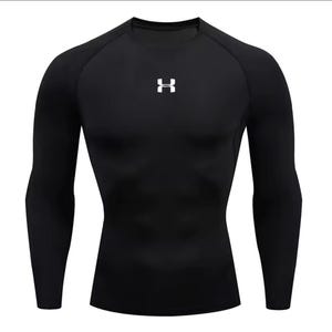 May include: Black compression shirt with long sleeves. The shirt has a crew neck and a white logo on the chest. The fabric appears to be form-fitting and designed for athletic activities.